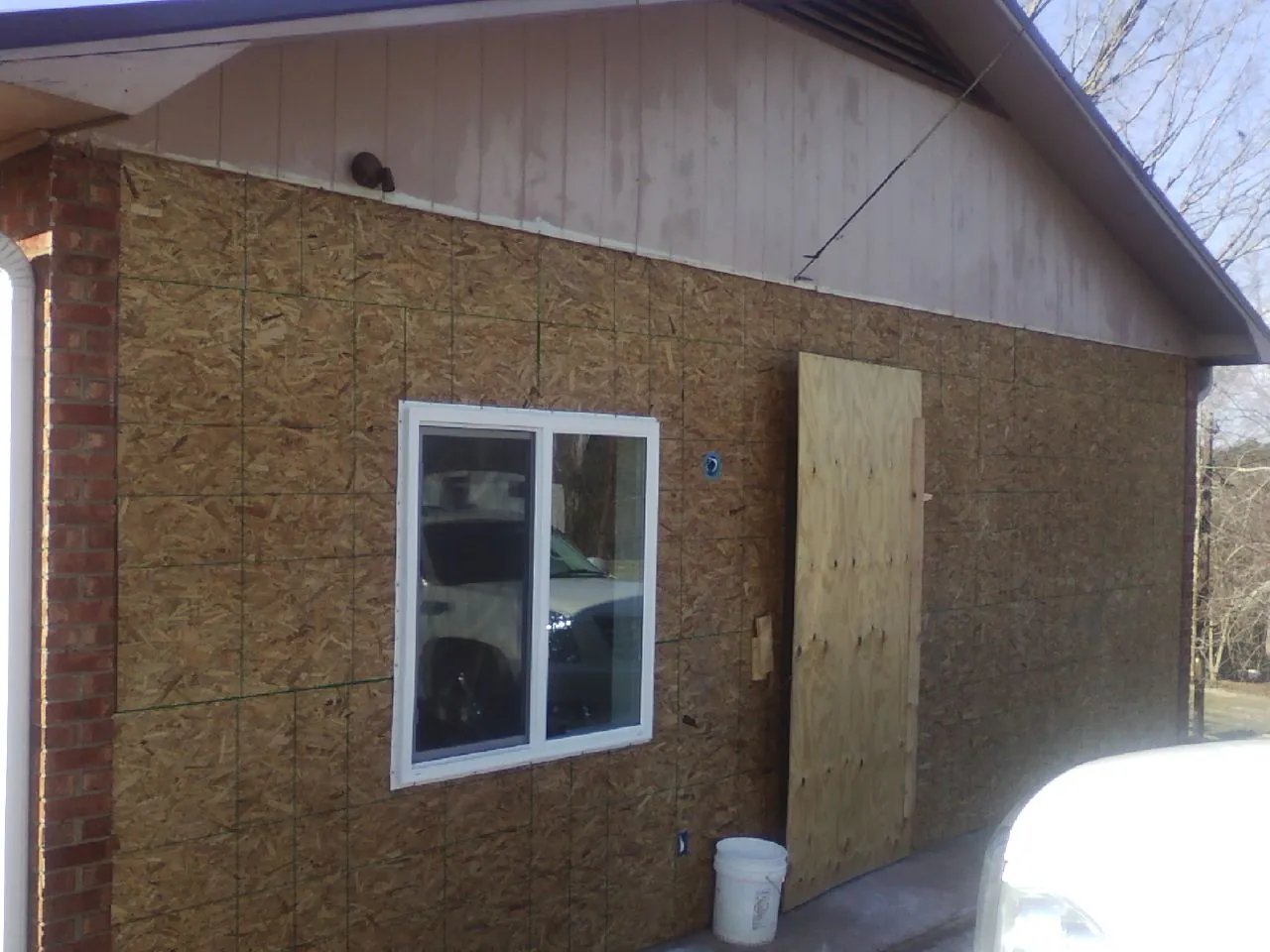 OSB sheathing on a garage addition wall before siding in Dorchester